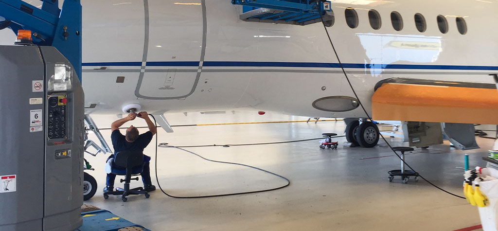 Certified Permagard installer applying aviation-grade coating on aircraft